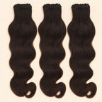 Three raw Indian wavy human hair bundles standing side by side