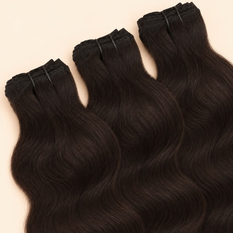 Three raw Indian wavy bundles angled to show the machine-sewn wefts