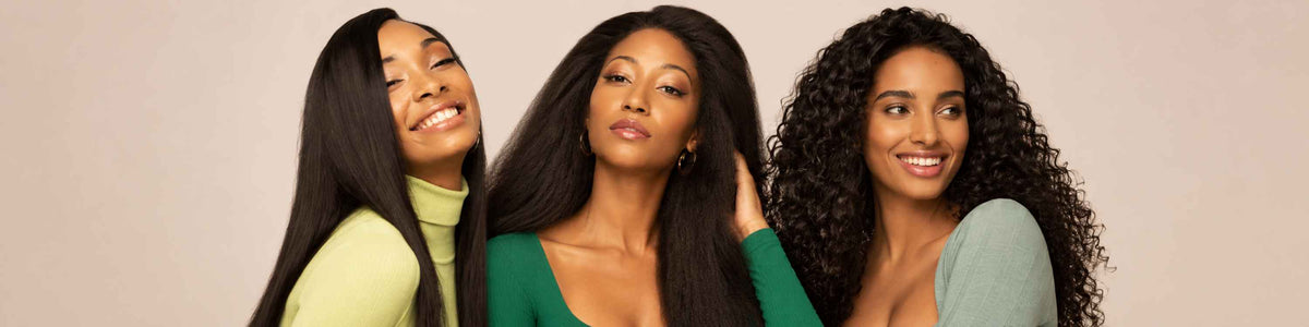 Three women with long, straight black hair posing together against a solid beige background, wearing green, yellow, and light blue tops.