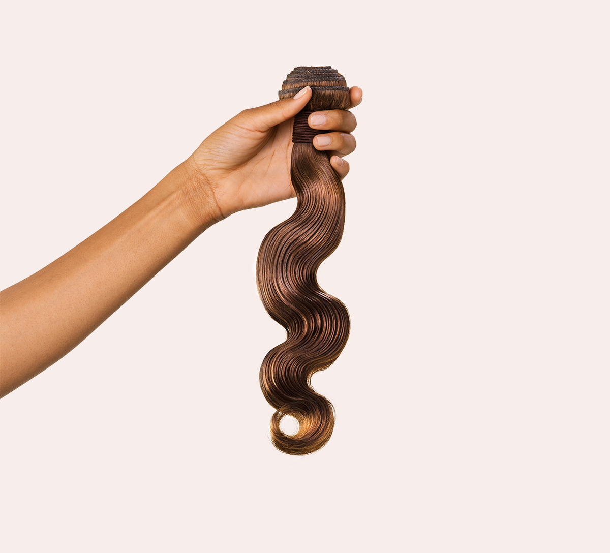 Close-up of the body wave pattern on caramel brown virgin hair