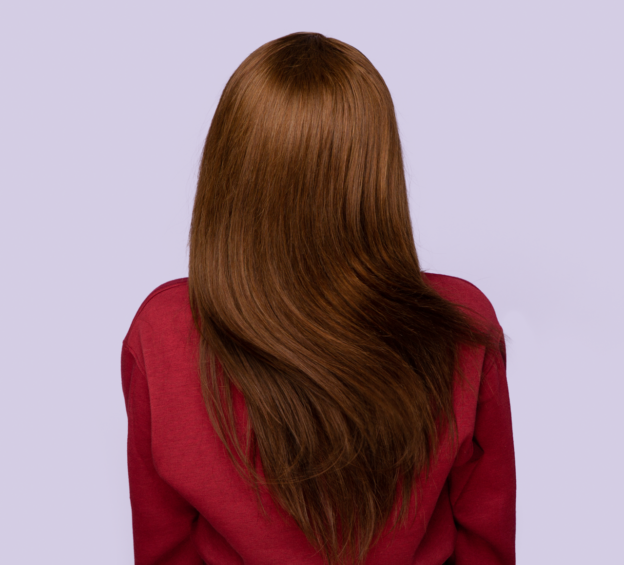 Model wearing a 4 caramel brown straight sew-in, front view
