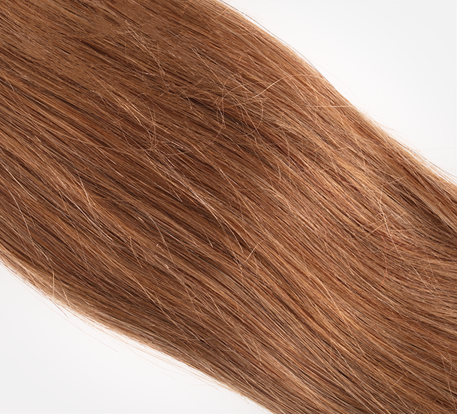 Curly human hair swatch clipped to the stylist color sample ring