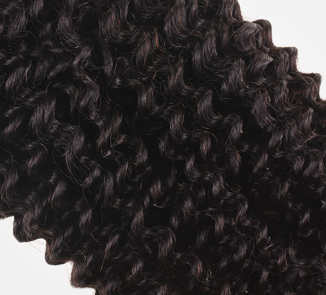 Hair texture swatch on the stylist ring showing the wave pattern up close