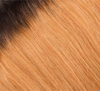 Close-up of dark roots melting through a 5x5 transparent lace closure