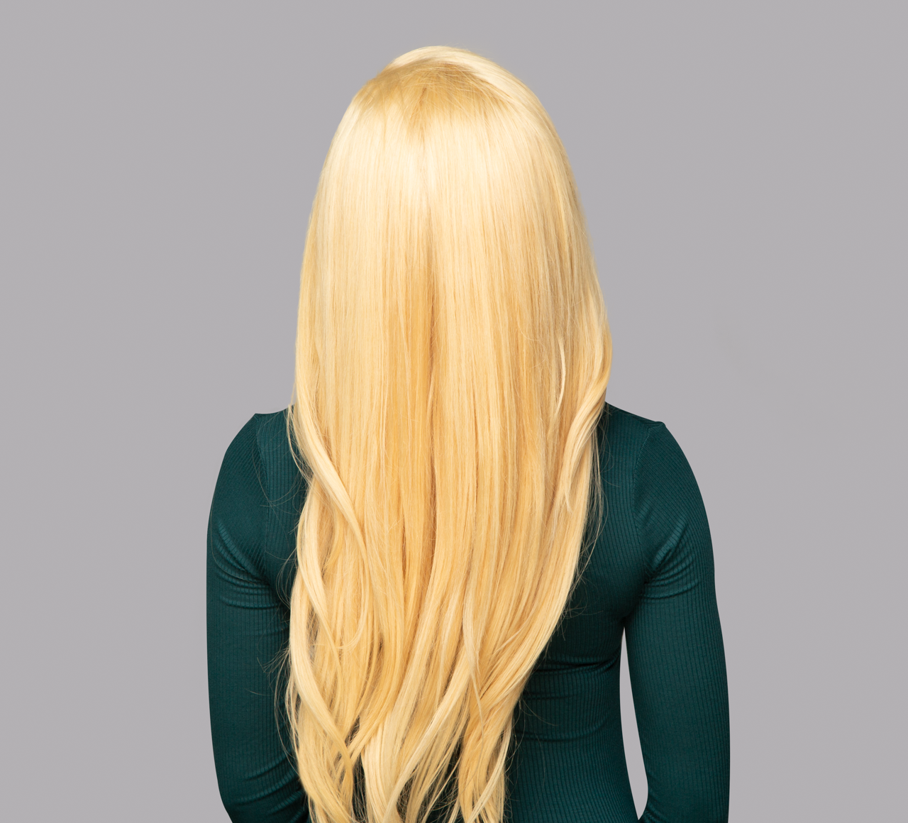 Back view of a 613 blonde Indian straight install styled sleek and long
