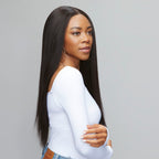 Hand holding a natural black yaki straight HD lace closure piece