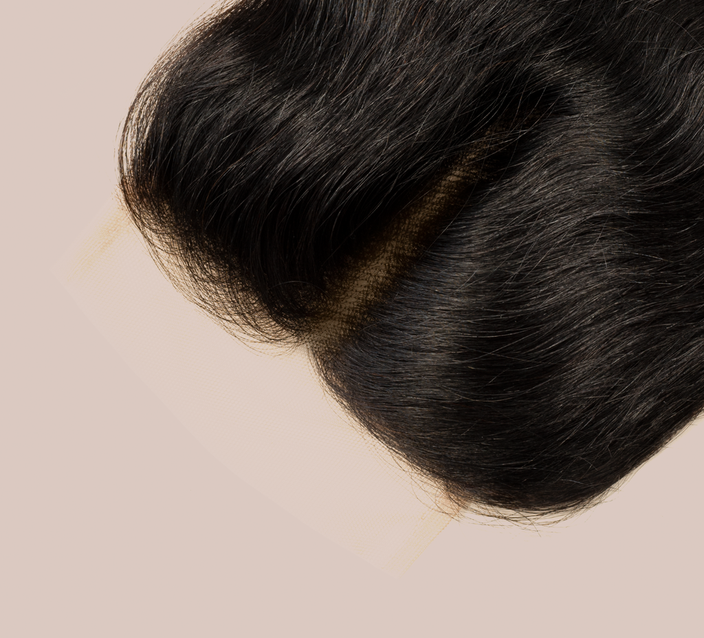 Close-up of transparent lace on a jet black loose wave closure