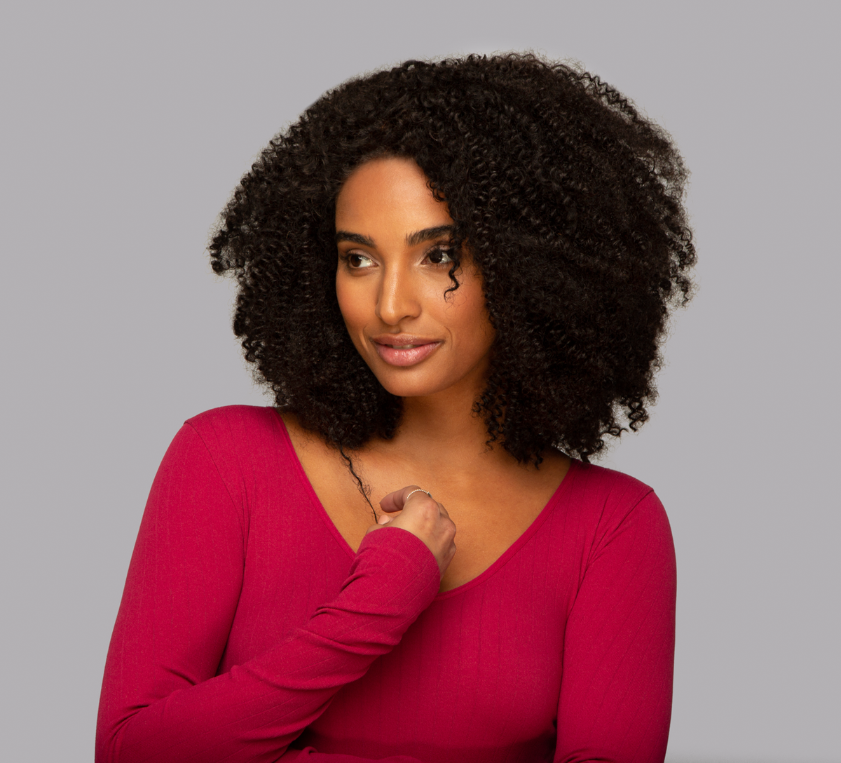 Side view of a natural black Brazilian curly install with defined coils