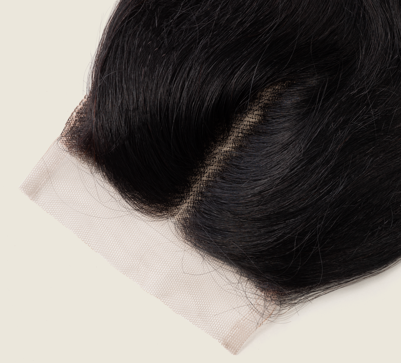 Close-up of the HD lace parting on a jet black body wave closure