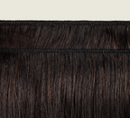 Natural black Brazilian yaki straight bundle coiled on a plain background