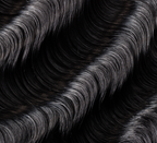 Back view of a jet black loose wave sew-in showing soft movement