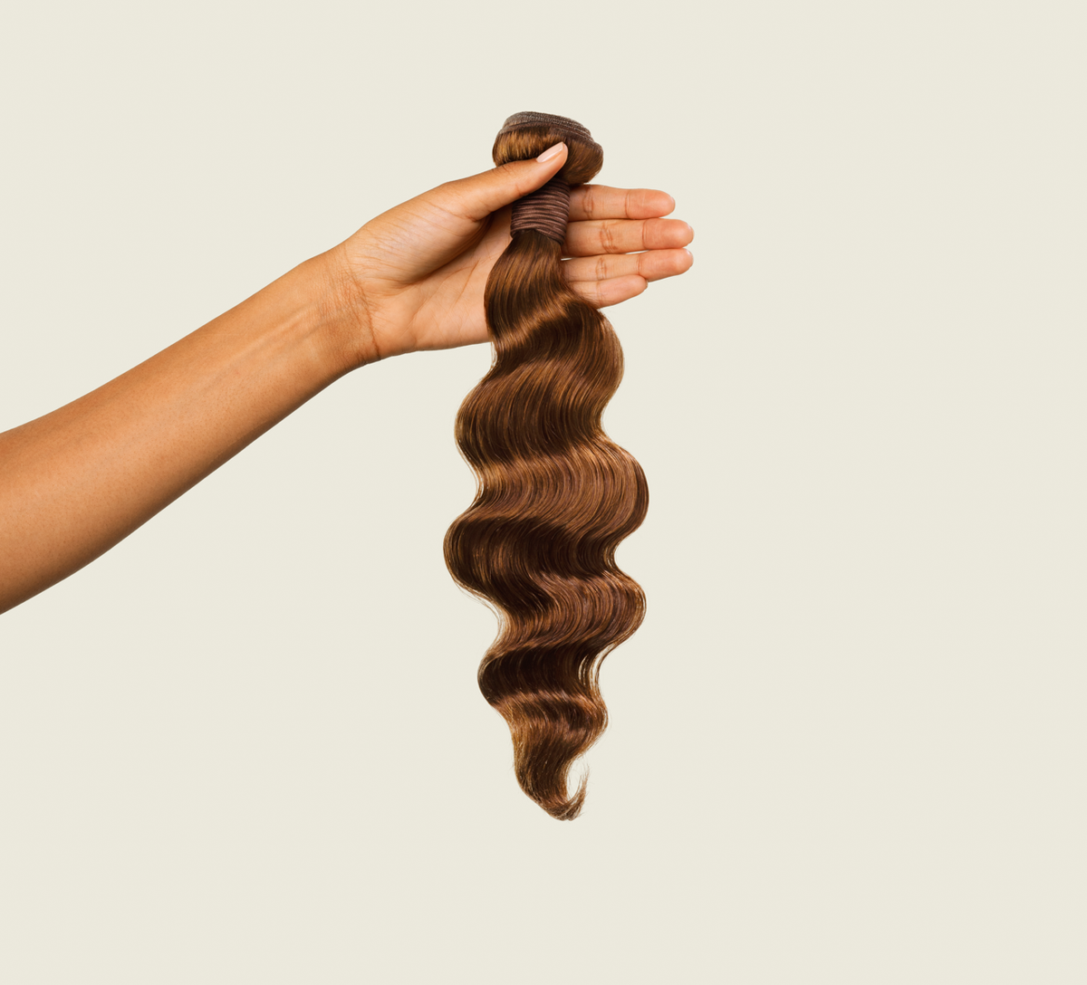 Close-up of the relaxed wave pattern on caramel brown virgin hair