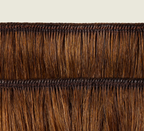 Side view of a caramel brown body wave install past the shoulder
