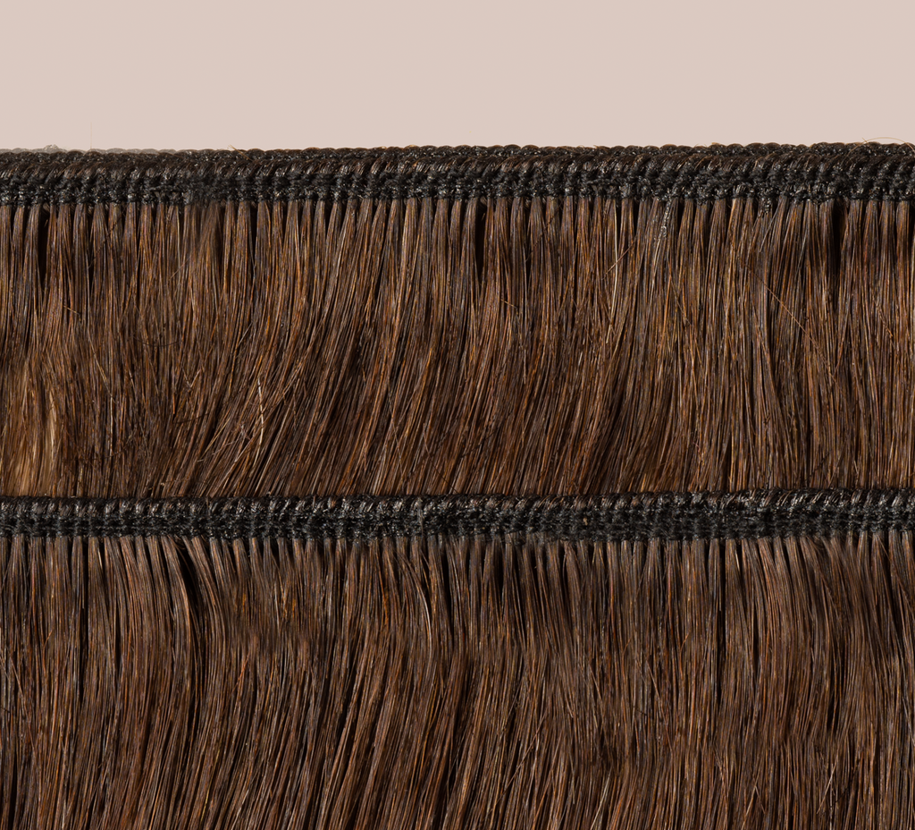 Side view of a chocolate brown loose wave install past the shoulder