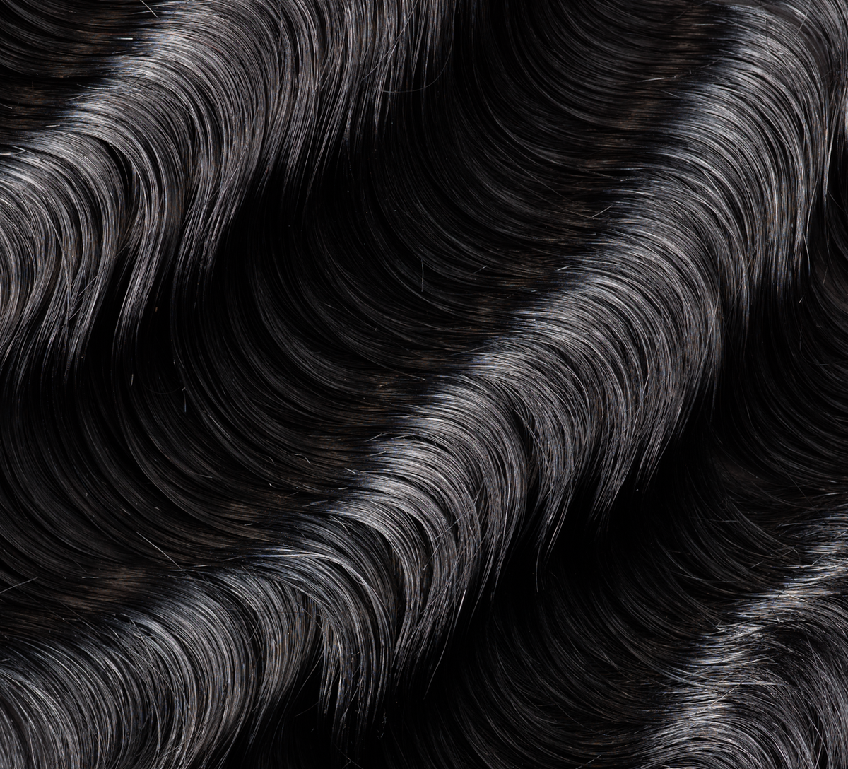 Back view of a jet black loose wave install with a 5x5 closure