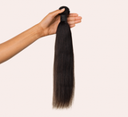 Hand holding a natural black yaki straight bundle to show the weft
