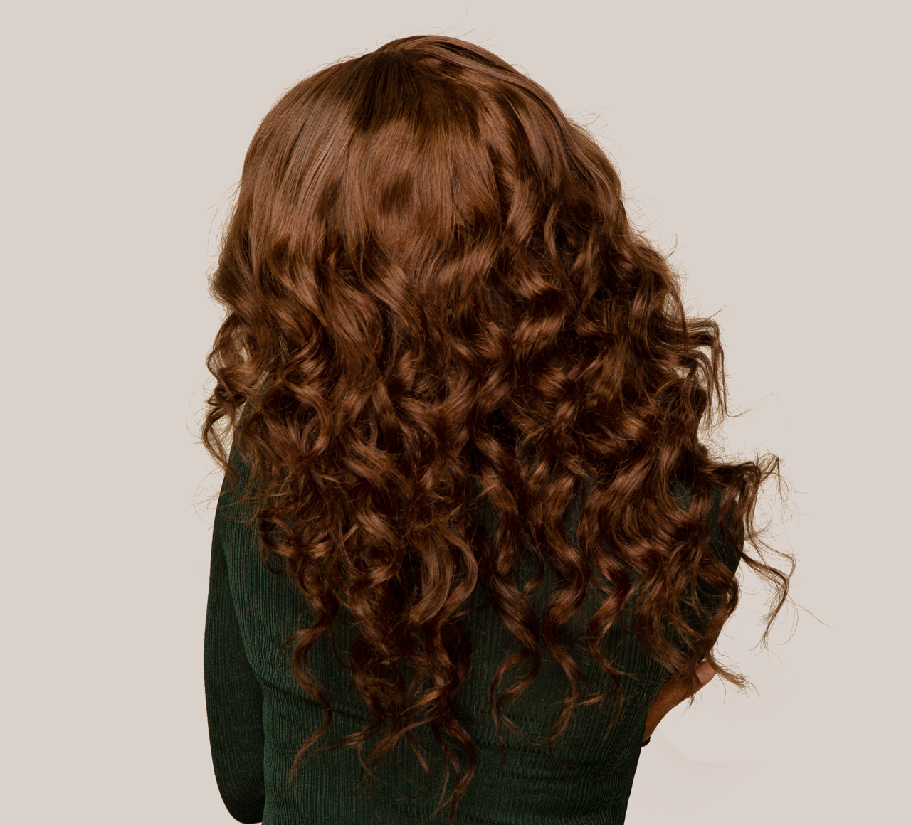 Model wearing a 4 caramel brown loose wave sew-in, front view