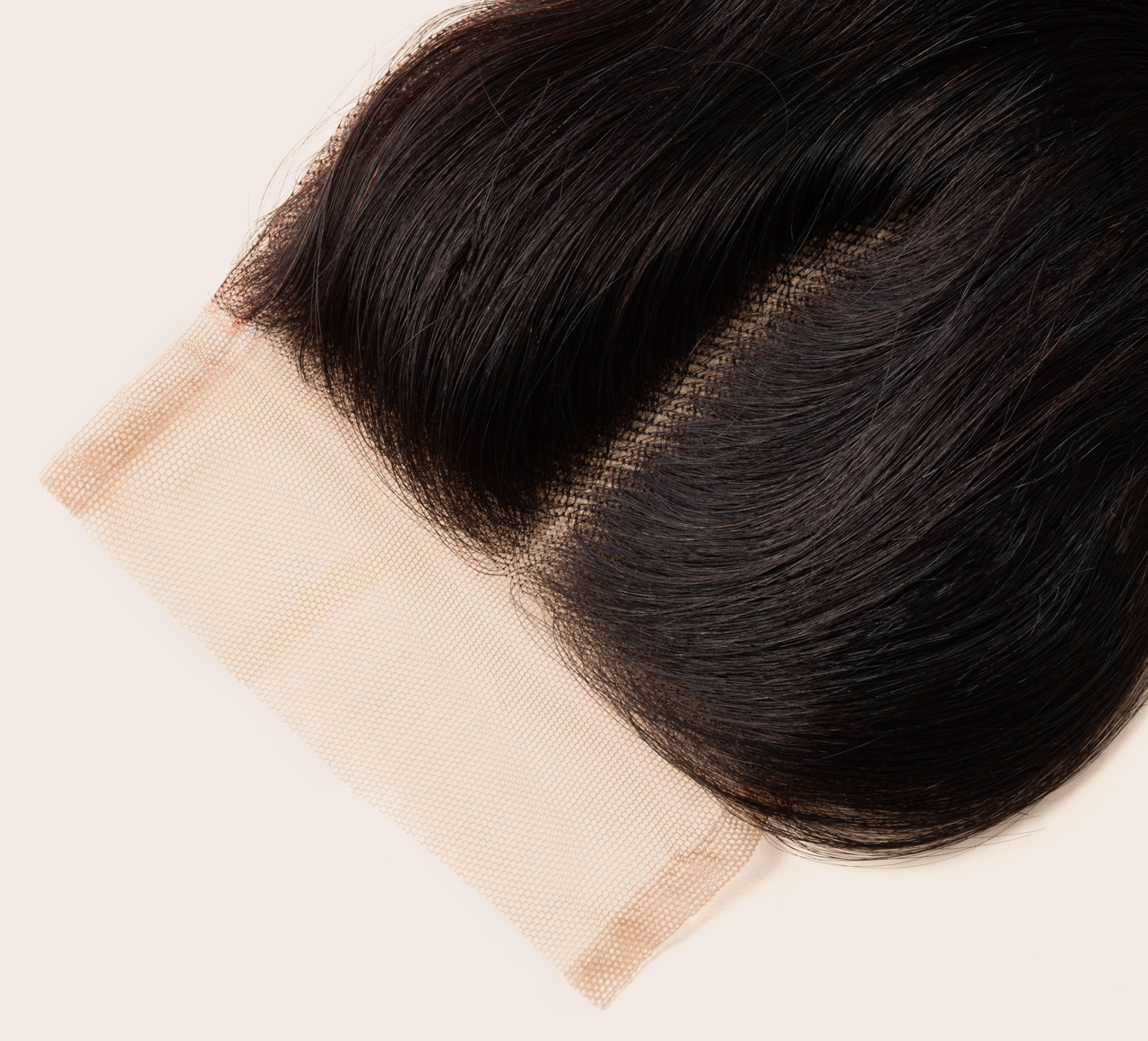 Back view of a natural black body wave install topped with a closure