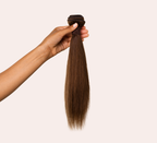 Close-up of the double machine weft on a caramel brown straight bundle
