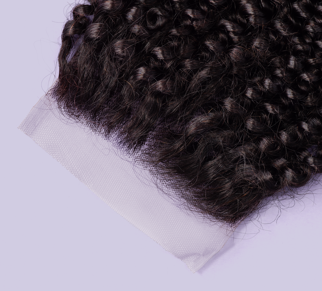 Close-up of the spiral coils along a 4x4 curly transparent lace closure