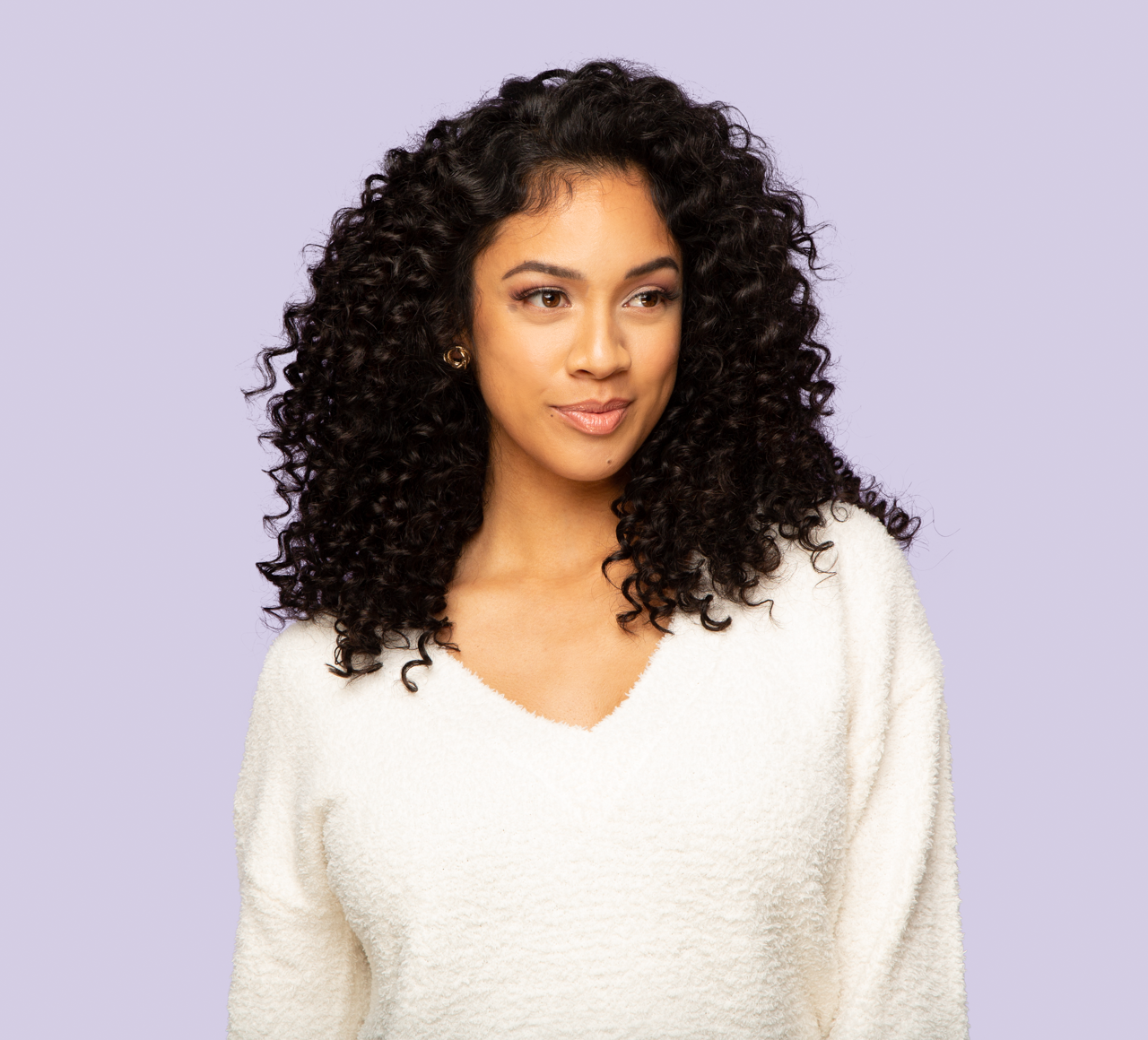 Model wearing a natural black Brazilian deep wave sew-in, front view