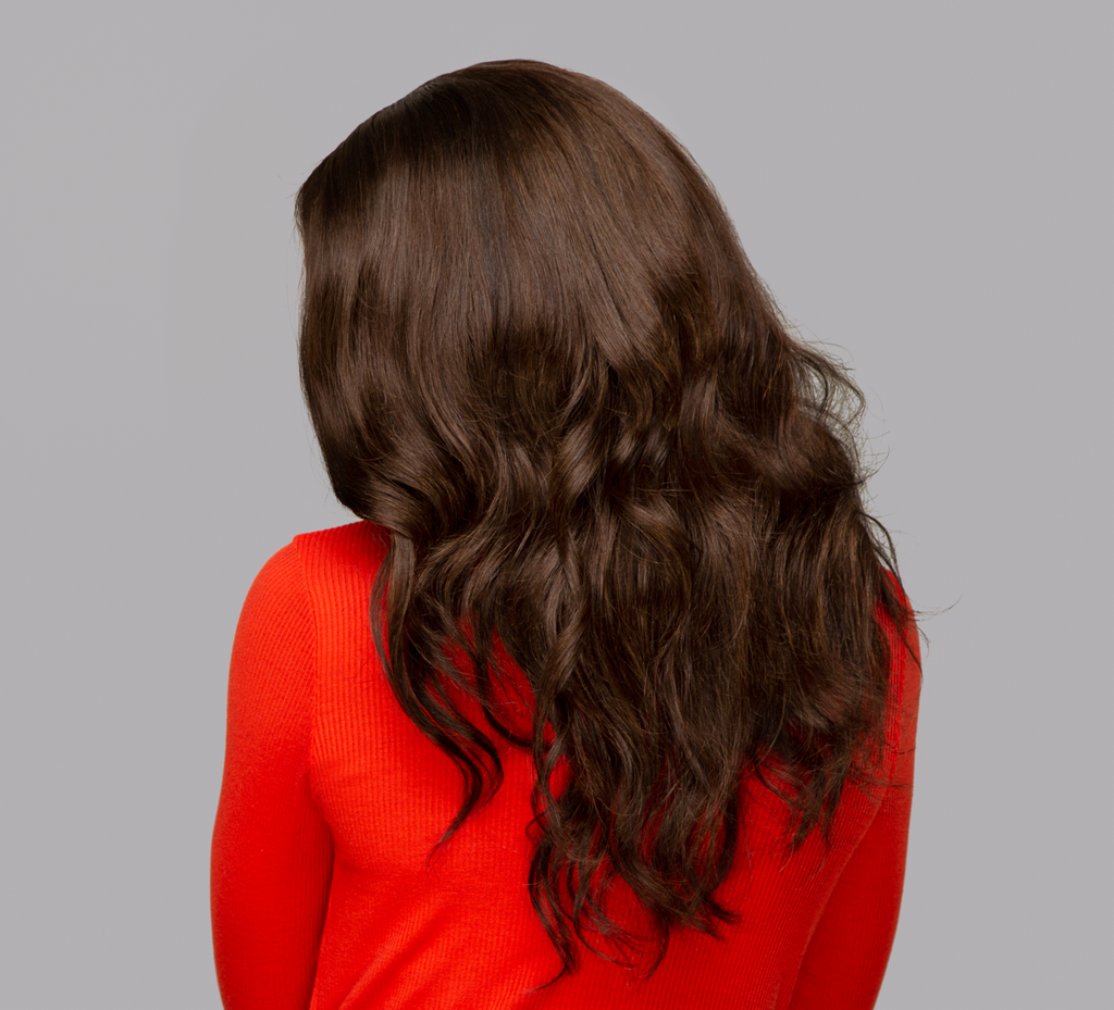 Close-up of the body wave pattern on chocolate brown virgin hair