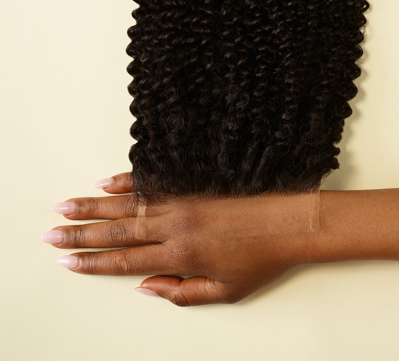 Natural black Brazilian curly 5x5 HD lace closure laid flat on white