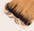 Close-up of dark roots blending into blonde along the frontal hairline
