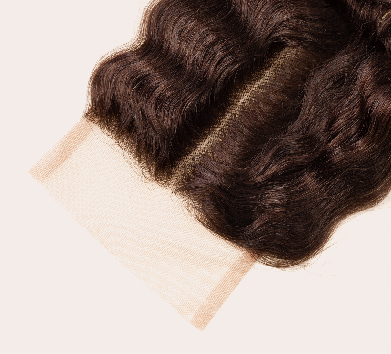 Close-up of transparent lace on a chocolate brown deep wave closure