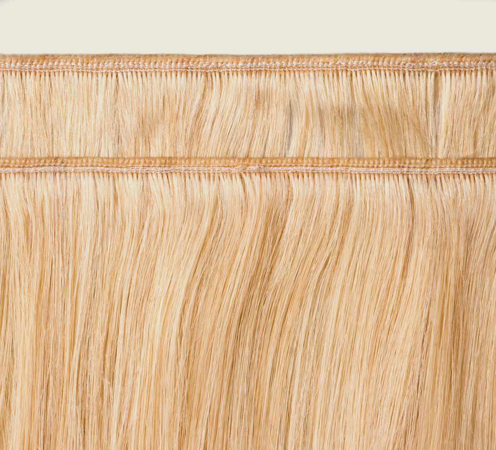 Detail of the double machine weft on a 613 blonde straight bundle