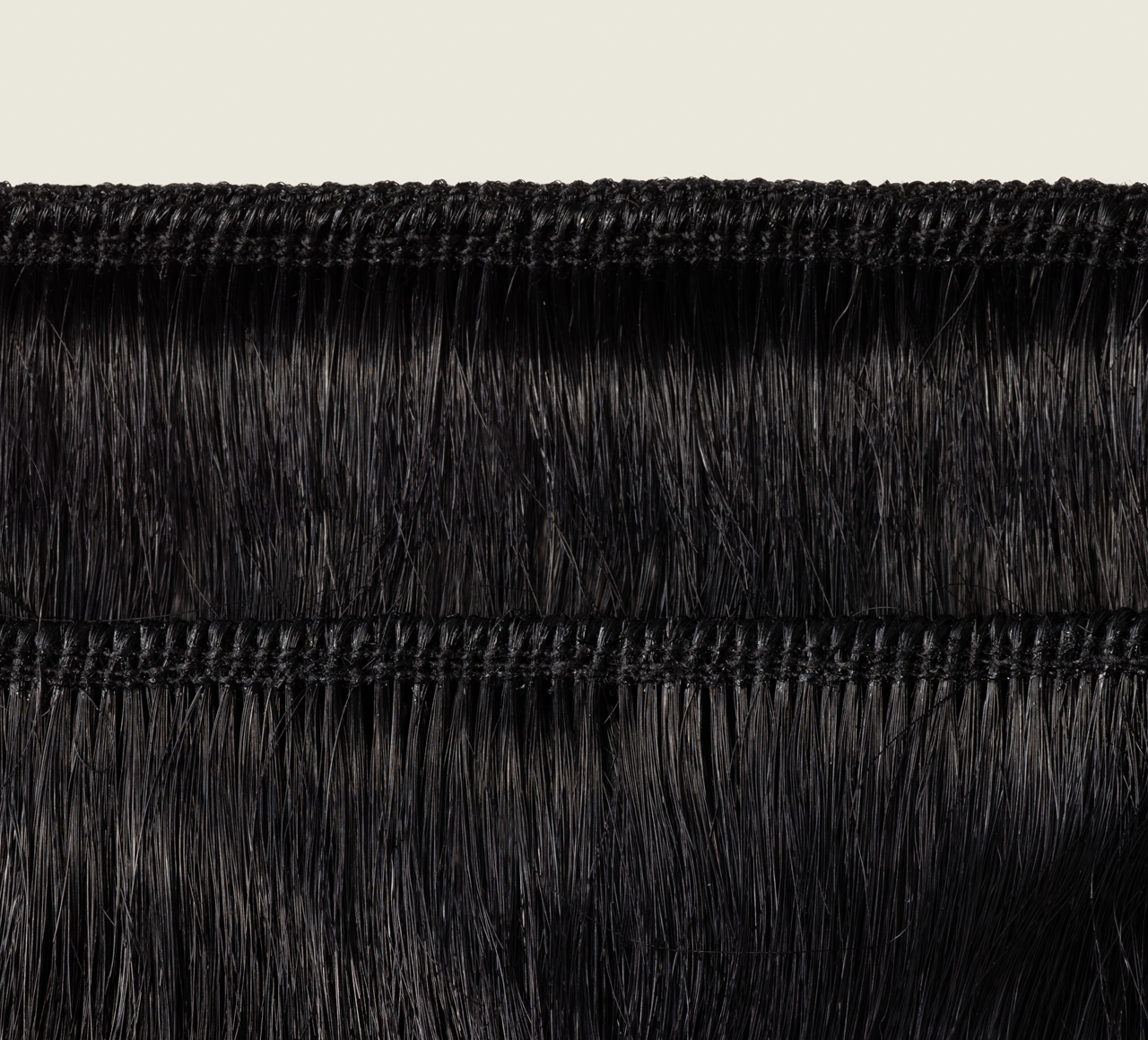 Back view of a jet black body wave sew-in showing bounce and shine