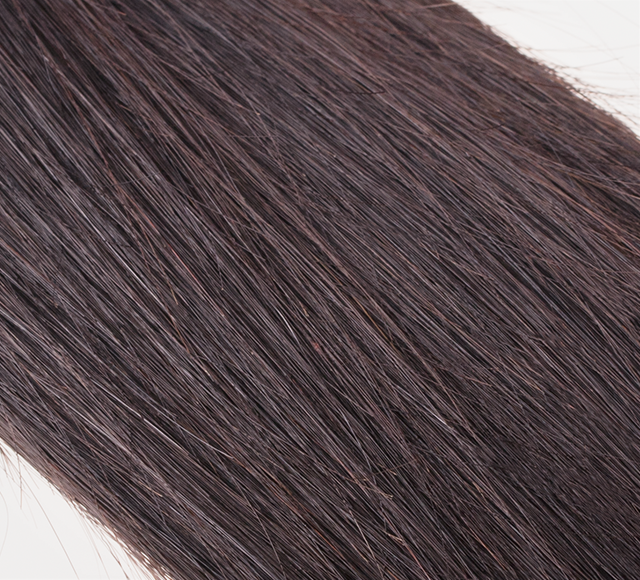 Dark brown human hair swatch clipped onto the stylist sample ring