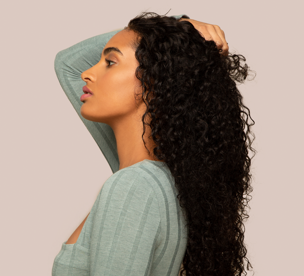 Model wearing a natural black water wave 13x4 transparent lace frontal
