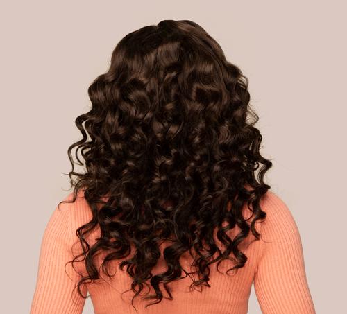 Model wearing a 2 chocolate brown loose wave sew-in, front view