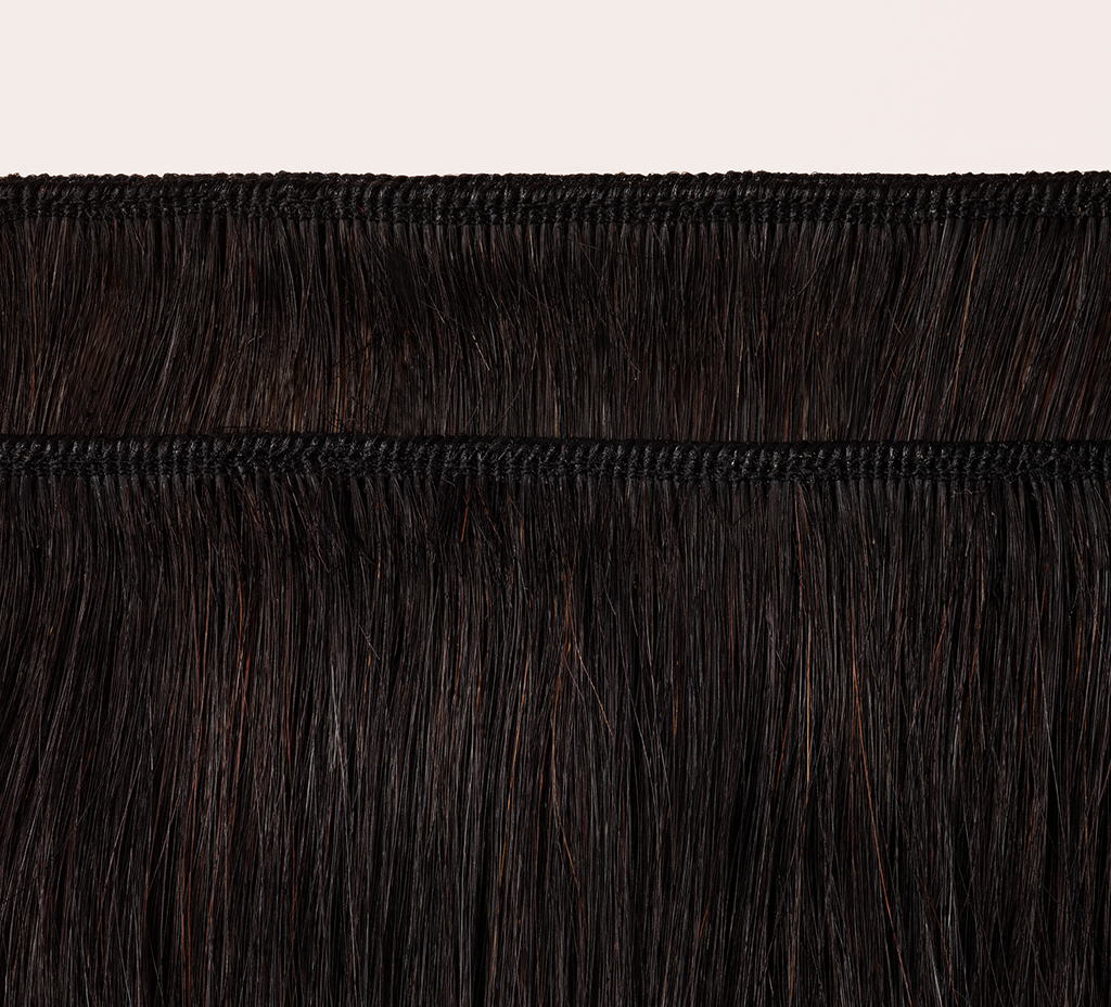 Back view of a Brazilian kinky straight sew-in showing body and thickness
