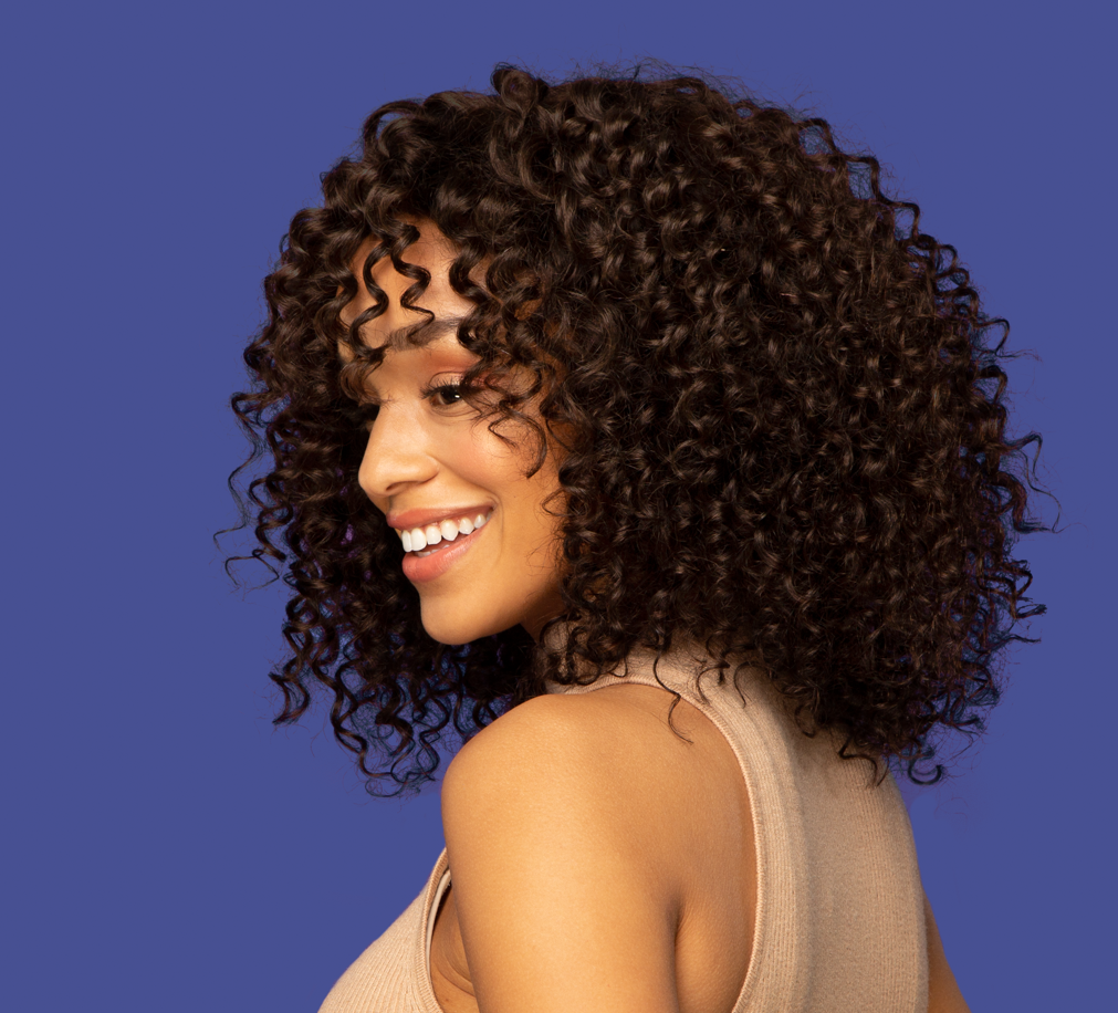 Model wearing a 2 chocolate brown deep wave sew-in, front view