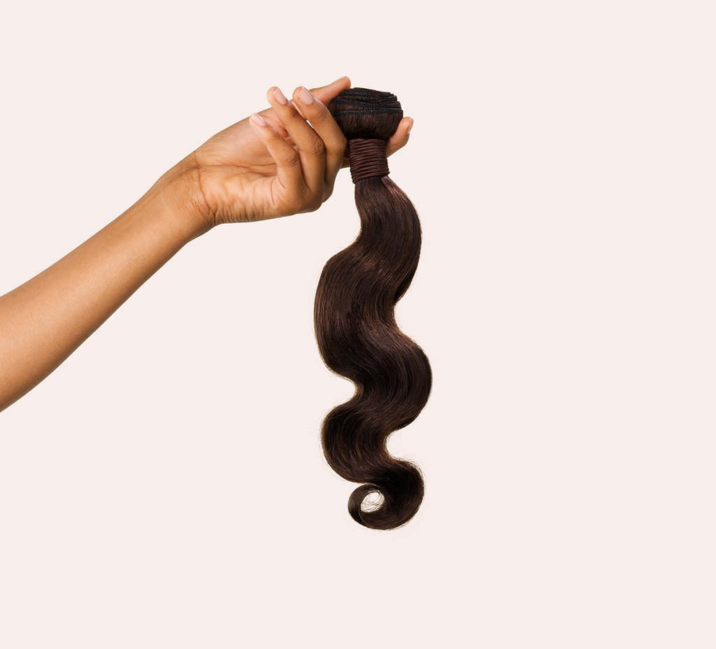 Side view of a chocolate brown body wave install past the shoulder