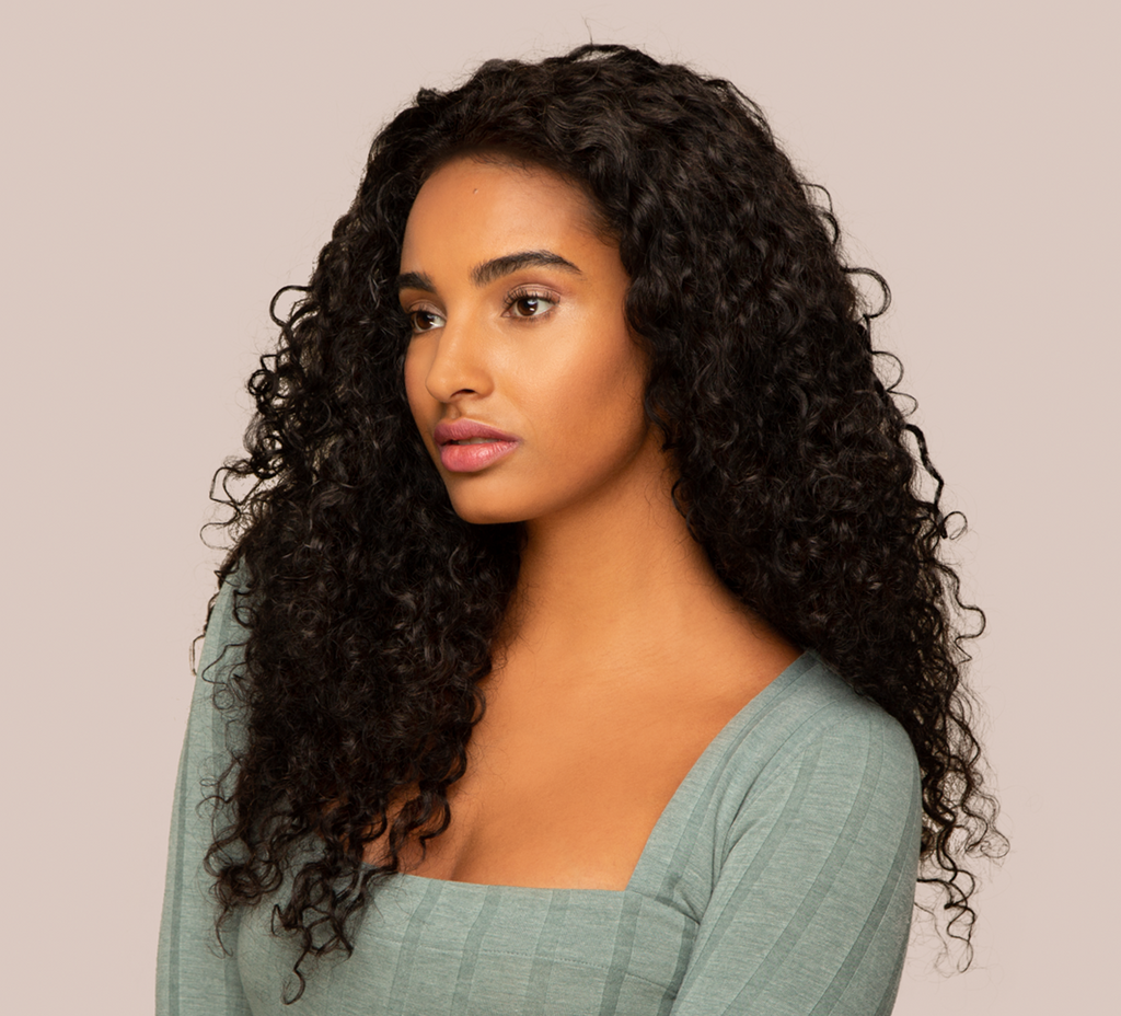 Model wearing a natural black water wave 4x4 lace closure, front view