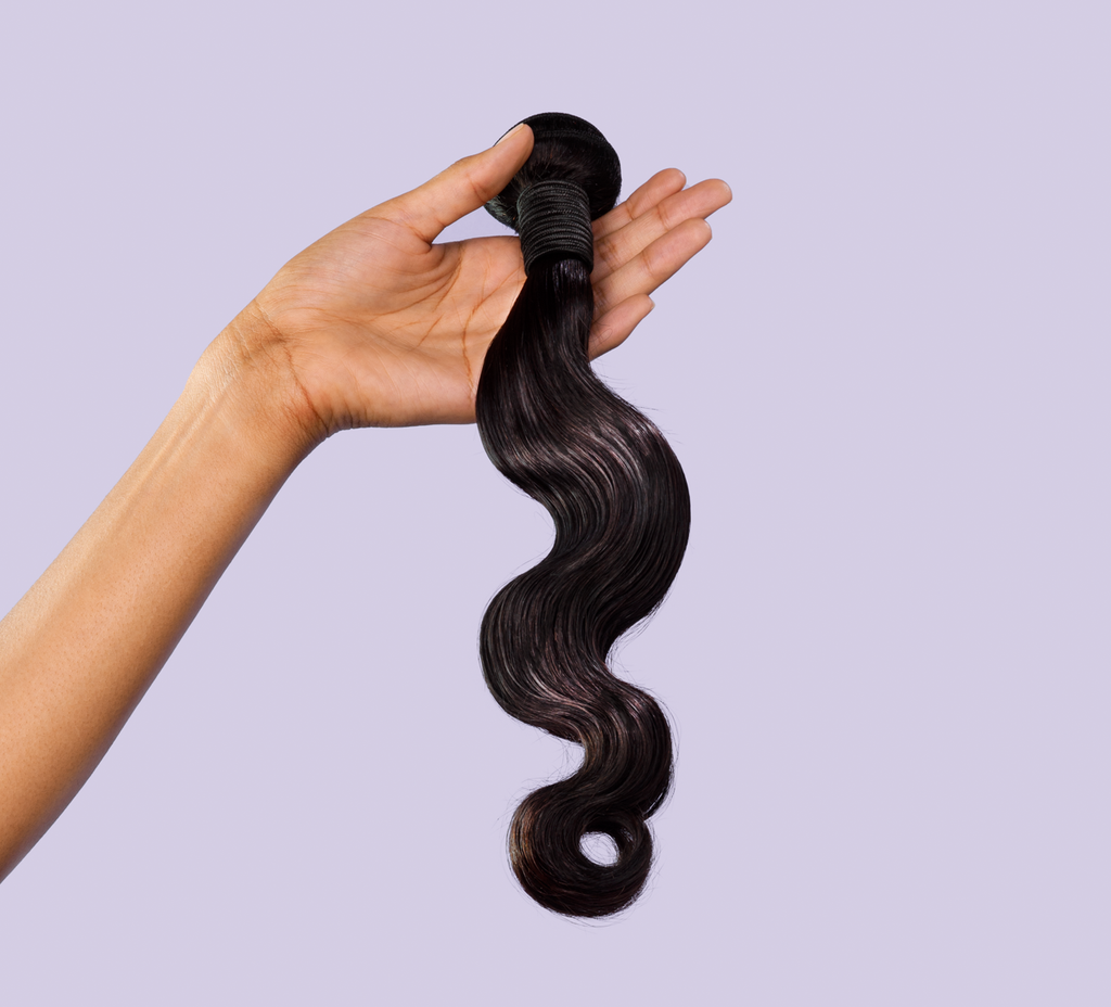 Side view of a natural black Malaysian body wave install past the shoulder