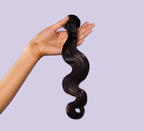 Side view of a natural black Malaysian body wave install past the shoulder