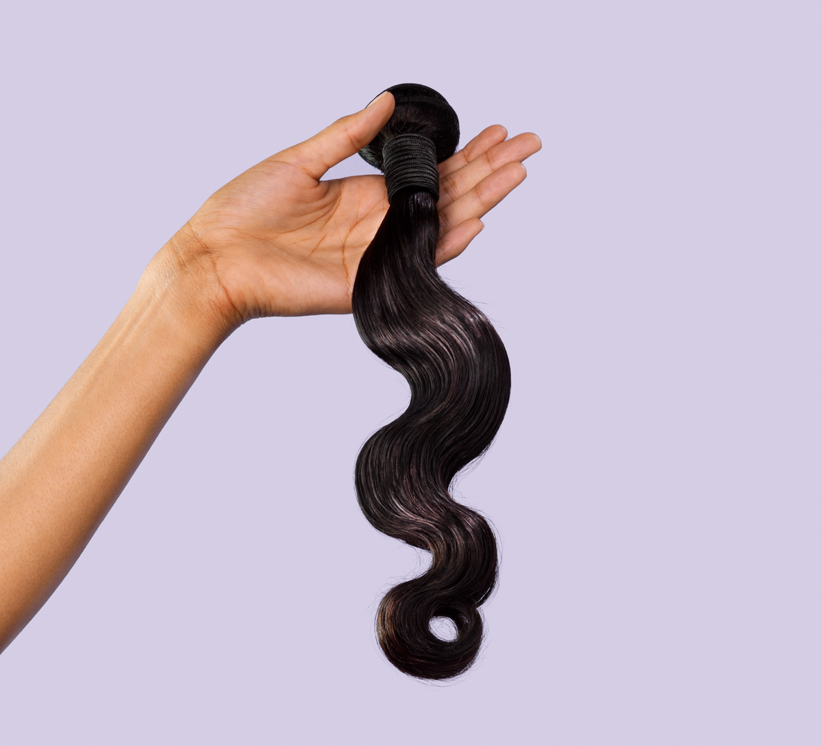 Side view of a natural black Malaysian body wave install past the shoulder