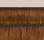 Side view of a caramel brown loose wave install past the shoulder