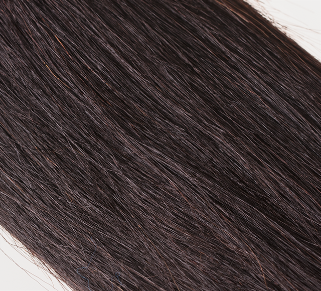 Fanned display of virgin human hair swatches on a metal sample ring