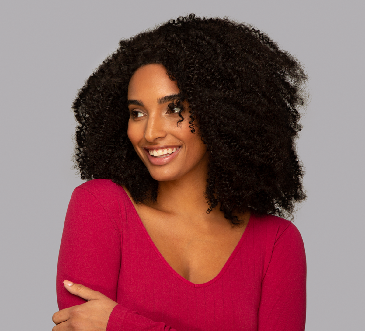 Model wearing a natural black Brazilian curly 4x4 lace closure, front view