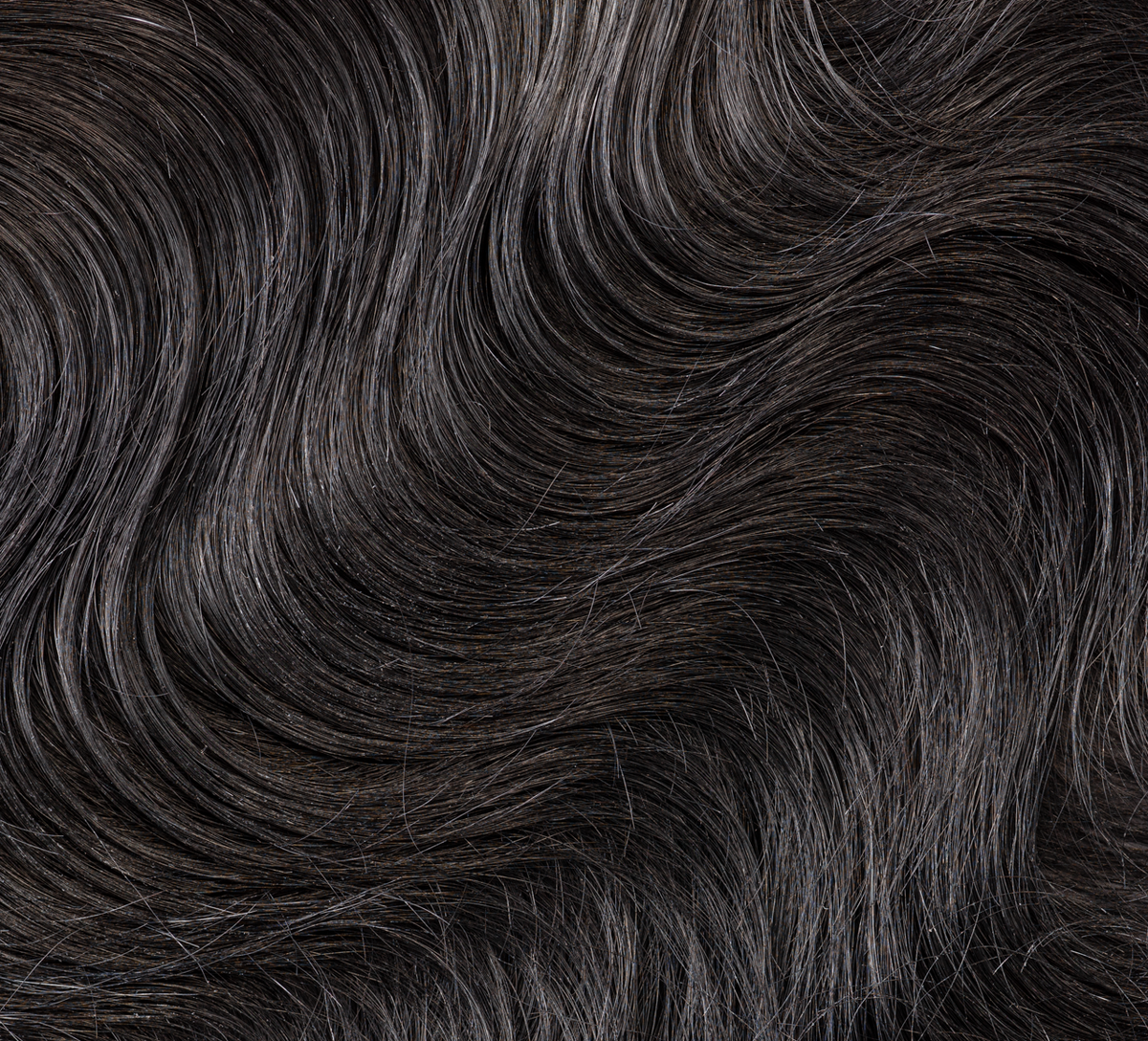 Back view of a jet black body wave install with a 5x5 closure