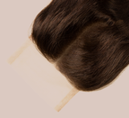Close-up of transparent lace on a chocolate brown loose wave closure