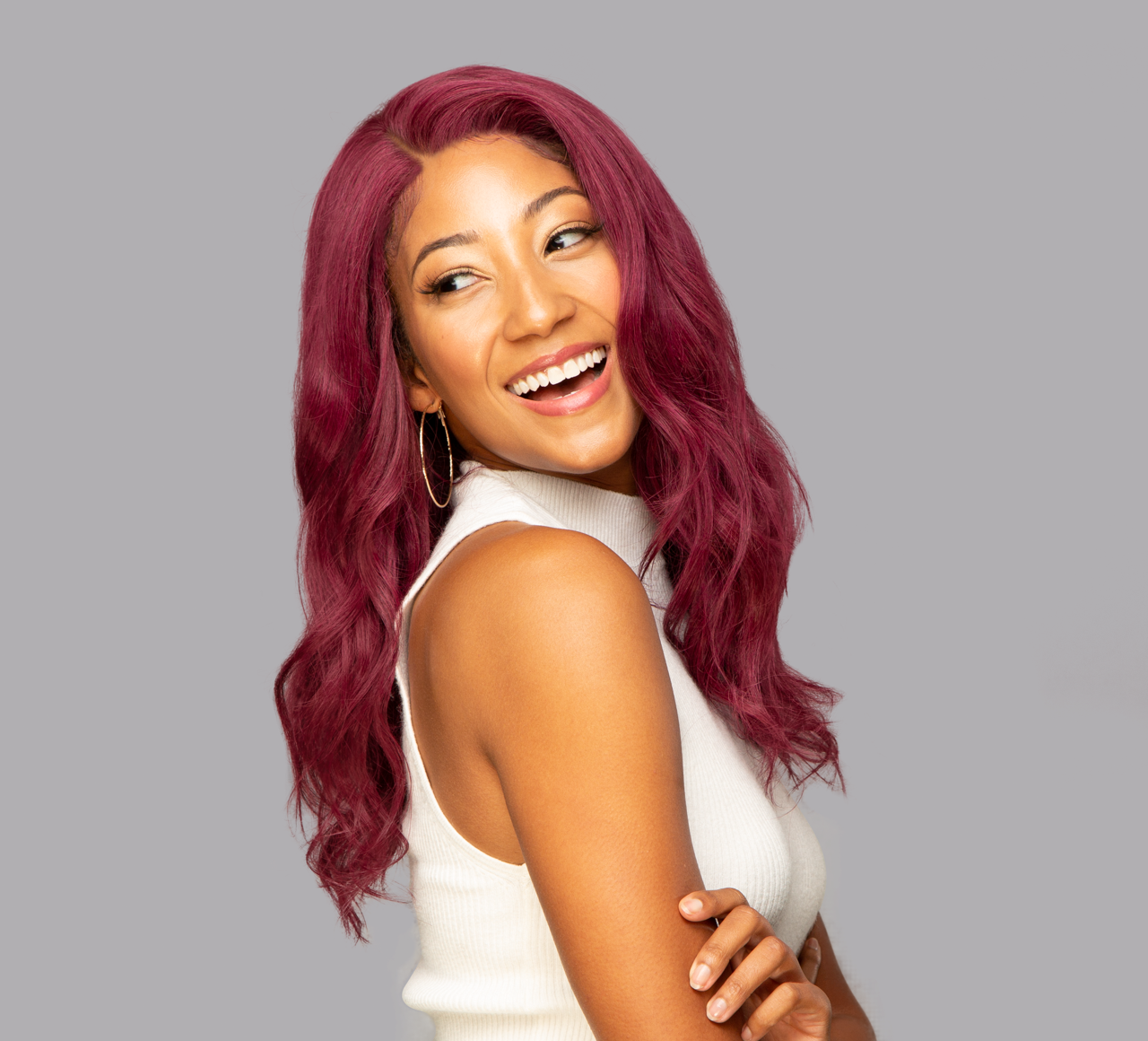 Model wearing a 99J burgundy body wave sew-in, front view