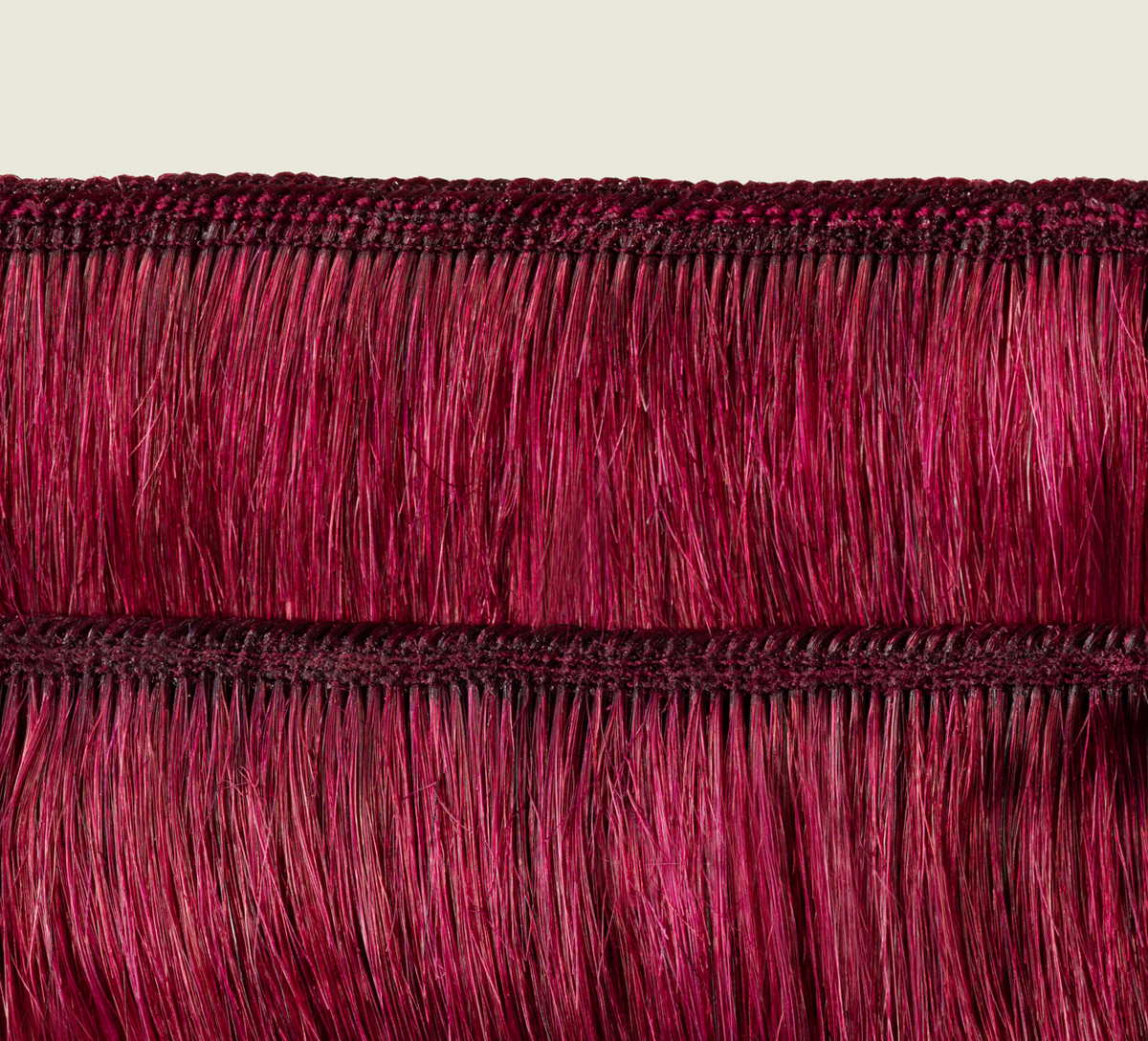 Side view of a burgundy body wave install past the shoulder
