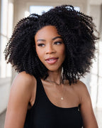 Close-up of the tight spiral curl pattern on virgin Brazilian curly hair