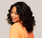 Model wearing a jet black 1 loose wave sew-in, front view